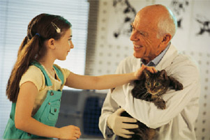 doctor holding a cat and girl is petting it